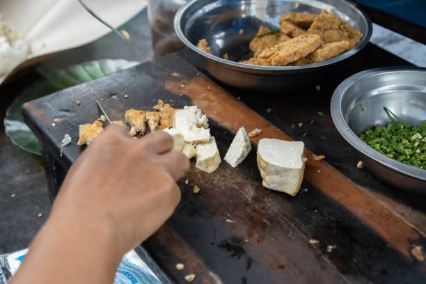 istock hand cutting tofu or slicing tofu 1364017994