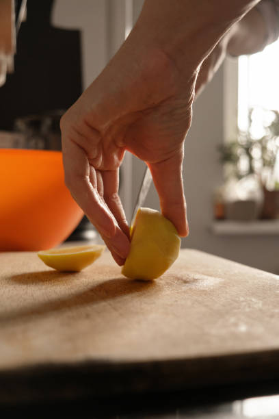 istock Woman cutting vegetable on table in kitchen 1364018212