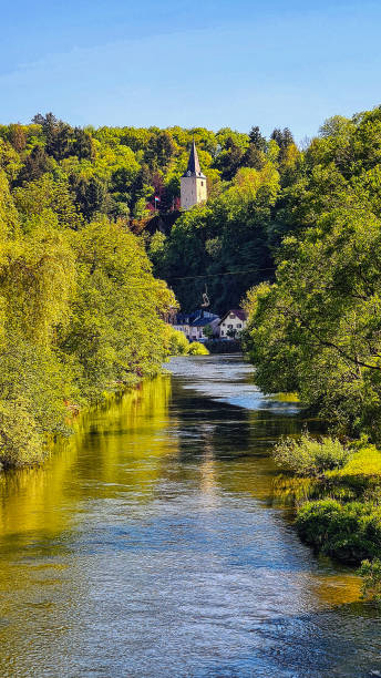 The river Our in Vianden, Luxemburg. The river Our in Vianden, Luxemburg. At the sides of the river is the forest, which is reflected in the water. vianden stock pictures, royalty-free photos & images