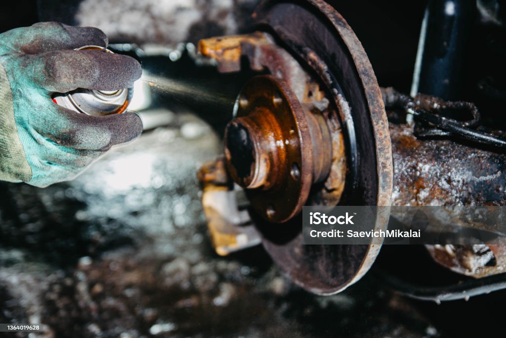 treatment of the hub and brake disc with rust spray, brake cleaner. Cleaner Stock Photo