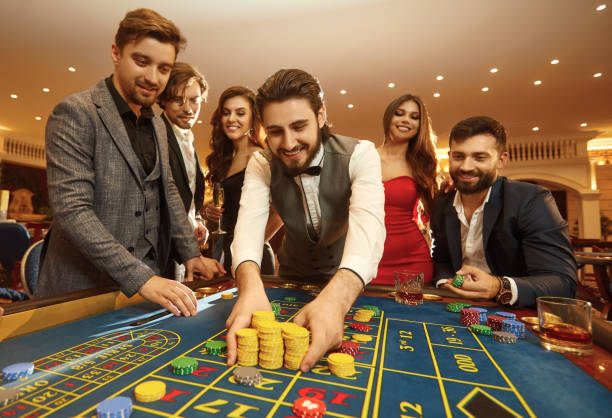 istock Happy guy playing gambling at a casino roulette 1364019955