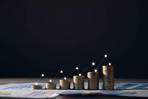istock Stacks of  coins with graph paper. 1364020442
