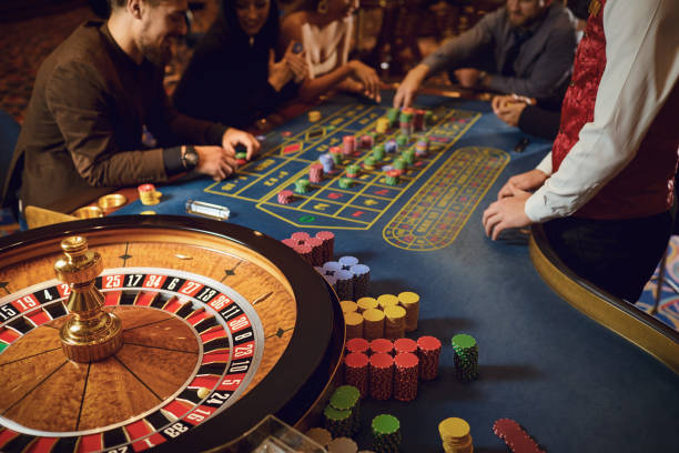 Hand of a croupier on a roulette whell in a casino. Hand of a croupier on a roulette whell in a casino. Roulette betting poker. Gambling in a casino. casino stock pictures, royalty-free photos & images