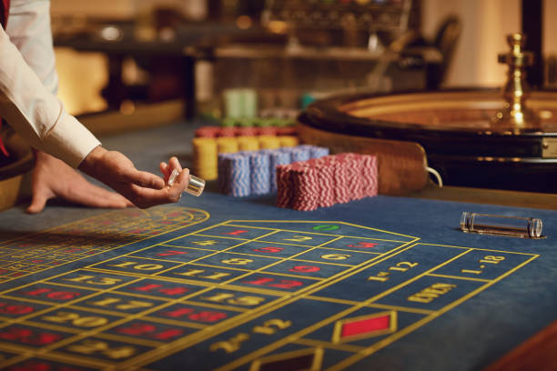 istock Croupier hand on the roulette table. 1364021454