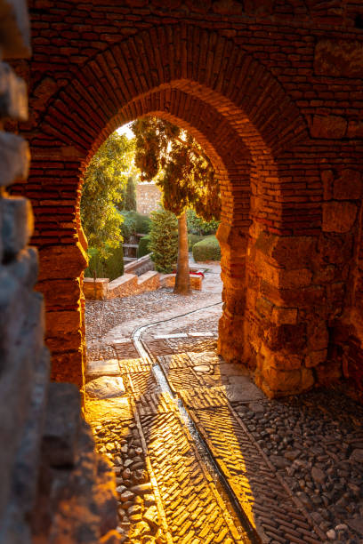 Beautiful sunset at the gate of the wall and the gardens of the Alcazaba in the city of Malaga, Andalusia. Spain. Medieval fortress in arabic style stock photo
