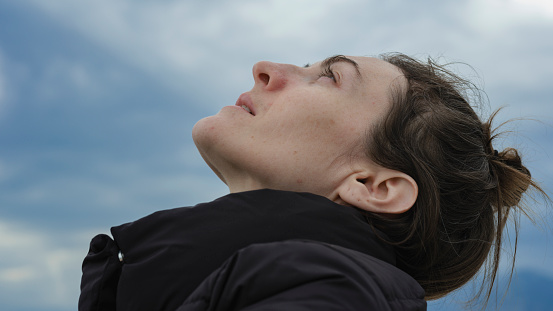 portrait of a young woman looking at the sky