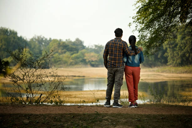 Couple admiring view at riverbank
