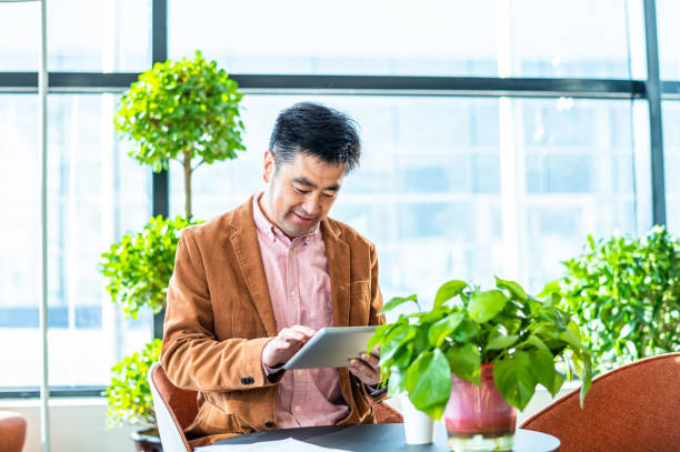 istock Asian businessman working in office 1364024434