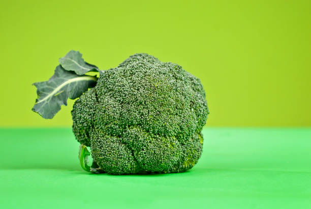 istock Broccoli on a green background. Cabbage close up. Copy space and place for text near greenery. 1364024693