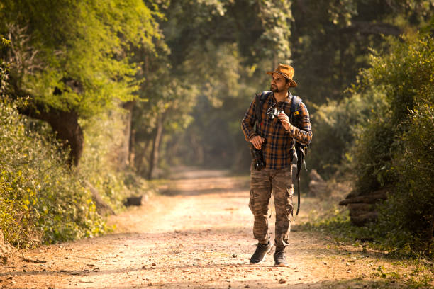istock Male hiker admiring nature in forest 1364026034