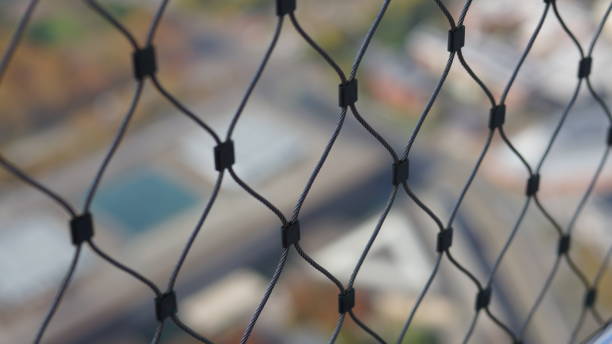 istock Cityscape through fence 1364027139