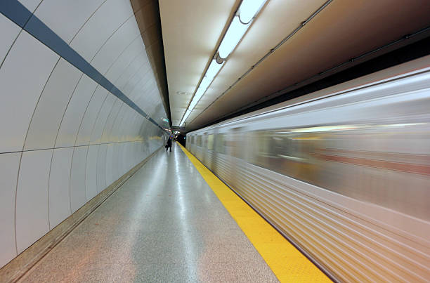 Subway train entering station A long exposure was used to give a streamlined motion blur look to the train. london england rush hour underground train stock pictures, royalty-free photos & images