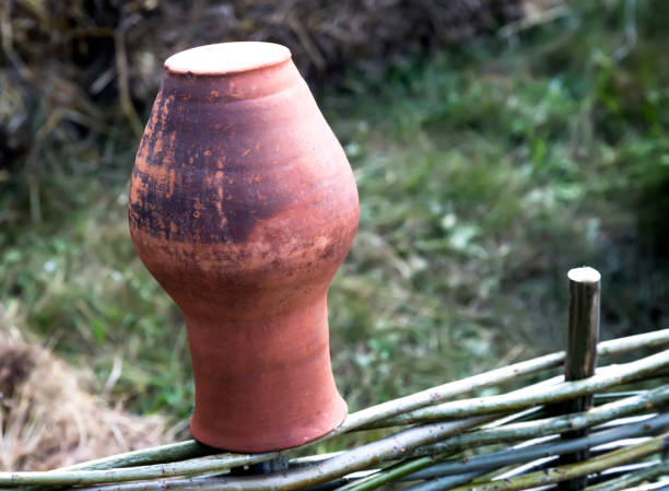 istock An ancient clay pitcher on a wicker fence. 1364028959