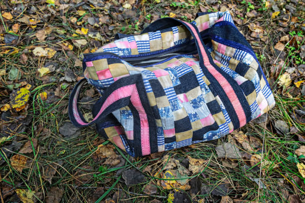 Knitted eco-friendly handbag with knitting tools in a creative studio