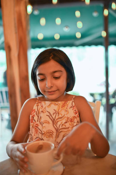 Girl drinking hot chocolate at a cafe