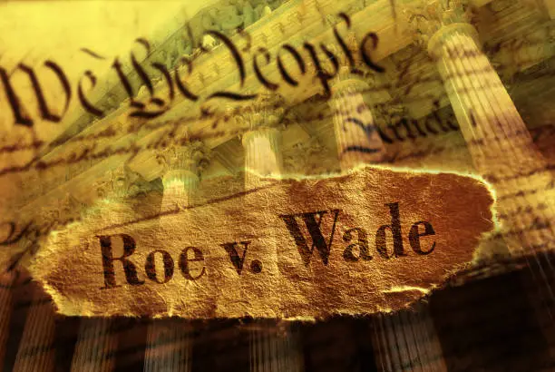 Roe V Wade newspaper headline on the US Constitution with the United States Supreme Court in background