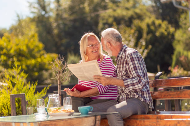 istock Senior couple reading in the backyard 1364034323