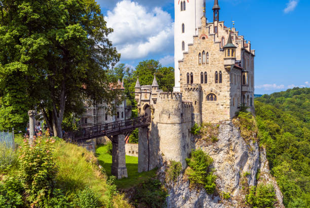 Lichtenstein Castle on mountain top, Germany, Europe. This famous castle is landmark of Schwarzwald, Baden-Wurttemberg. Scenic view of fairytale Lichtenstein Castle and old entrance bridge in summer.