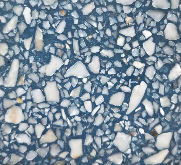 real blue terrazzo stone texture background for interior vintage mood and tone. white and grey irregular stone fragments on blue stone background. trendy and stylish composite stone texture.
