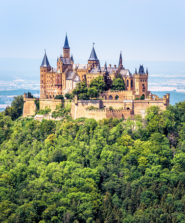Hohenzollern Castle or Burg on mountain top, Germany, Europe. It is landmark in Stuttgart vicinity. Vertical view of German castle like old palace in summer. Scenery of Gothic castle in Swabian Alps.