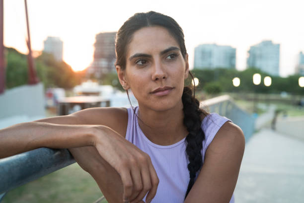 istock Mexican relaxed woman looking away while sitting outdoors during daytime 1364036336