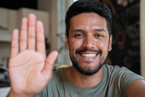 istock Cheerful latin man doing verification hand sign during video call 1364036749