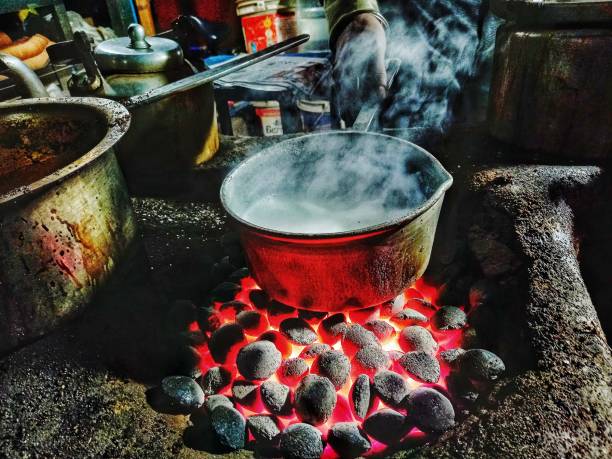 istock Milk boiling in a pot on a indigenious oven and steam forming like clouds 1364036928
