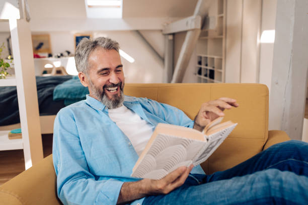 istock Senior man reading at his home office after work 1364037065