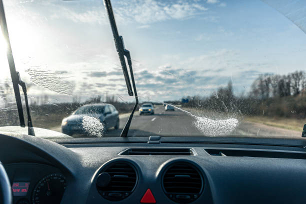 istock Car wipers clean windshields when driving in sunny weather. 1364038345