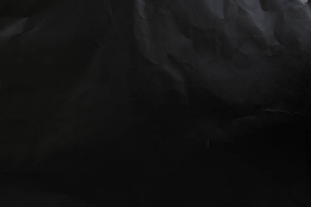 istock black wrinkled paper texture and background. top view 1364038529