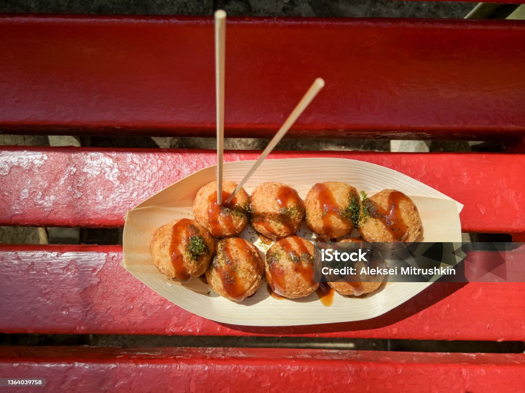 The national dish of japan takoyaki on a plate with sauce. The national dish of japan takoyaki on a plate with sauce. Takoyaki is made from batter with a piece of octopus inside. Takoyaki Stock Photo