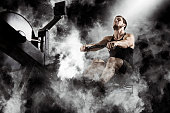 Bearded fit man using rowing machine