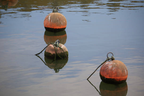 Floating Buoys on the water in Lyme Regis on the Cobb Floating Buoys levitation stock pictures, royalty-free photos & images