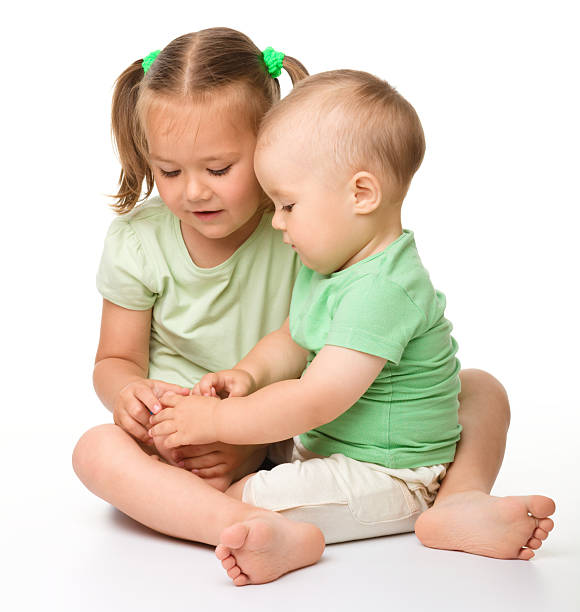 Two children are playing on the floor stock photo