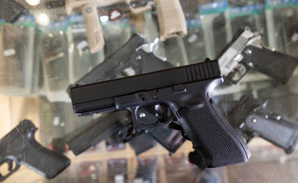 istock Pneumatic weapon on glass table in army store 1364049194