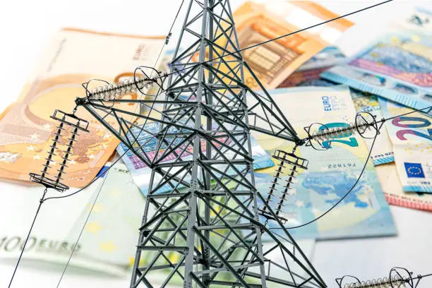 Electric tower and euro money, high voltage electric pylon on euro banknotes in selective focus, energy cost concept