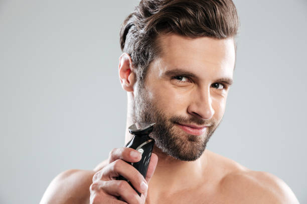 istock Handsome young man holding electric razor 1364053863