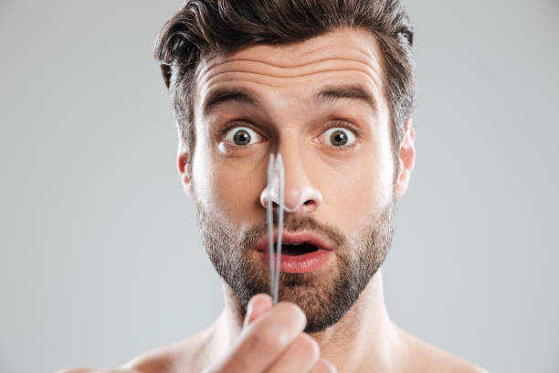 istock Shocked man with tweezer looked camera 1364054579