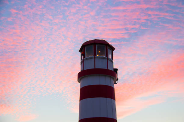 istock Lighthouse tower top in red and white colour from low angle on colourful sunset sky background, Podersdorf am See Lighthouse, Austria, Neusiedl lake