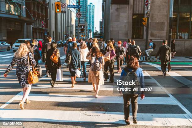 Crowd Of Unrecognisable People Crossing Street On Traffic Light Zebra Stock Photo - Download Image Now