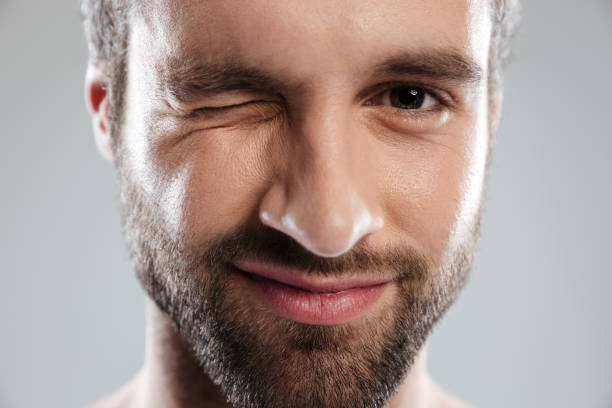 istock Cropped image of a bearded mans face winking 1364055446