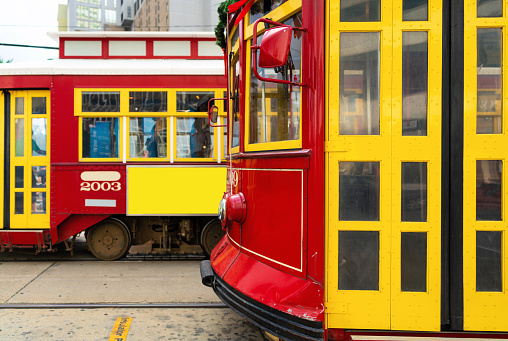 2 red and yellow New Orleans Street Cars