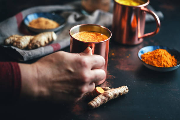 Healthy Golden Milk with Turmeric Fresh Made Golden Milk with Turmeric, Cinnamon and Ginger anti inflammatory stock pictures, royalty-free photos & images