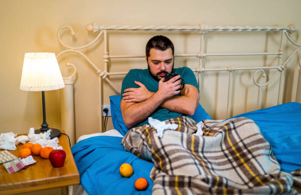 istock Sick young man at home in the bed with a cold 1364066599