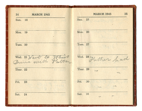A double page spread from an old diary, dated March 1945 (during World War Two), showing two entries handwritten in pencil. One, for Wednesday 21st March states, “Went to Whist Drive with Father” while the following Wednesday 28th March, “Father bad”, meaning he was quite unwell, and continued to be so for some days. (Identifying details removed.)