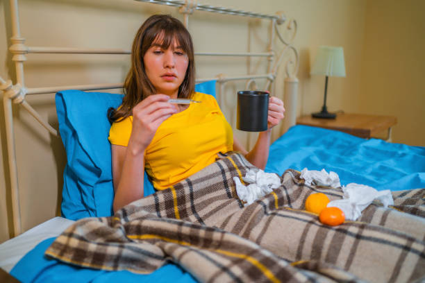 istock Woman measuring her temperature 1364067004