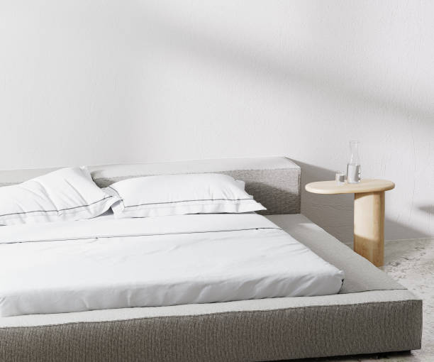istock room with bed and pillows and bedside table with white wall on background, 3d rendering 1364067184