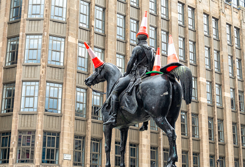 Glasgow, Scotland - Multiple traffic cones adorning the statue of the Duke of Wellington located on Royal Exchange Square in the city centre. The placement of traffic cones on the statue has become a Glasgow tradition.