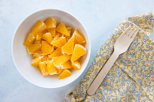 Chopped orange in a bowl, directly above.