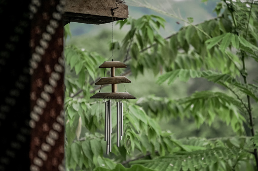 Aluminum pipe wind chimes with bamboo decoration on nature background